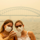 Tourists take a selfie while wearing face masks due to heavy smoke on Dec. 19, 2019 in Sydney, Australia.